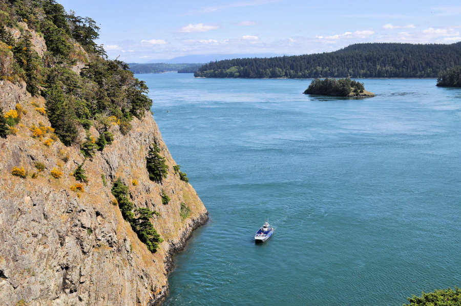 a boat in deception pass state park with little islands out in the water