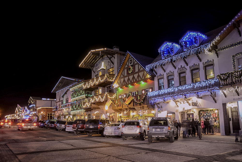 Dark night sky lit up by Christmas lights in several colors on a Bavarian-themed street in Leavenworth, Washingotn in winter.