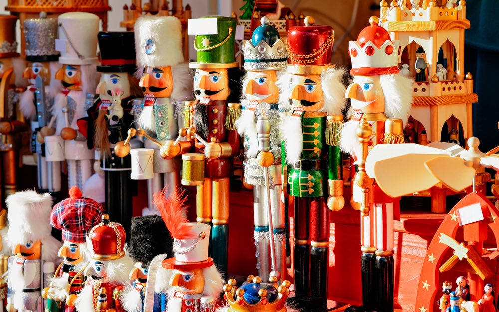 A collection of nutcrackers in a variety of colors and sizes in a Christmas style