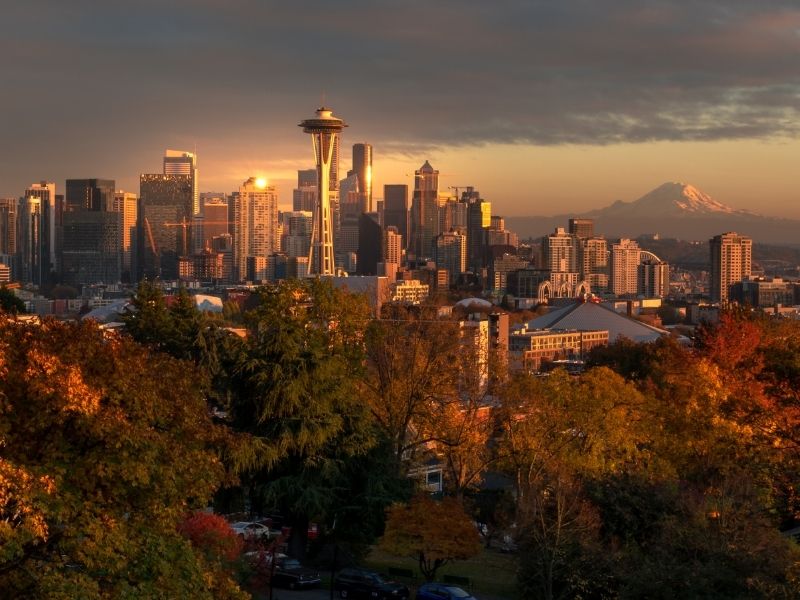 the iconic skyline of seattle as seen from one of the viewpoints around the city with fall colors and sunset tones