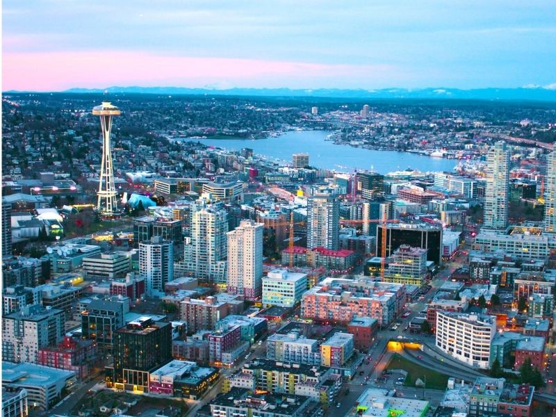 Aerial photo over Seattle at night with the Space needle prominently in the background