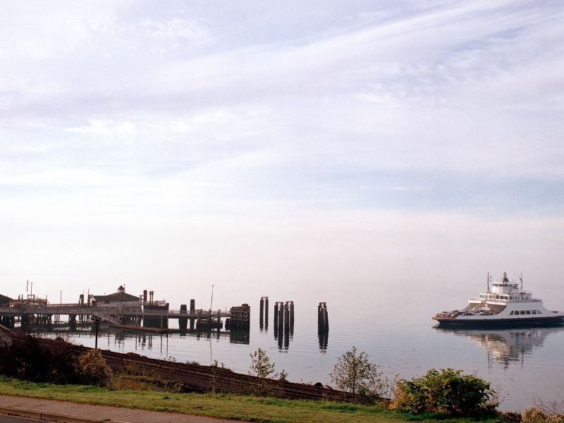 Boat coming into pier in early morning hours with a pastel colored sky.