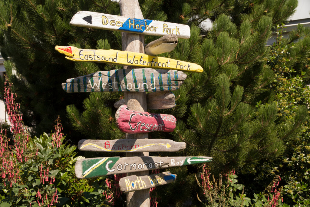 colorful painted wooden signs pointing to different places to visit in eastsound washington state