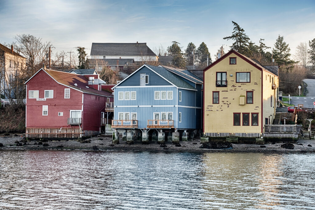 3 colorful buildings built right on the water in coupeville, one of the best washington small towns