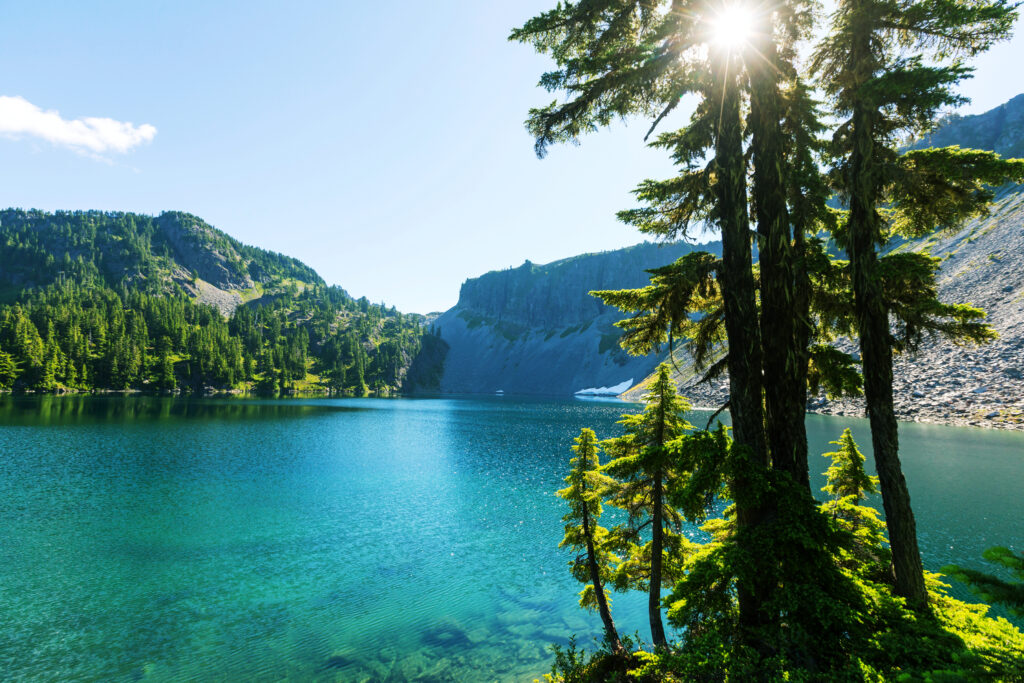 bright blue water of serenity lake in washington state with trees in the foreground