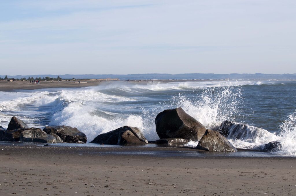 waves crashing against rocks on the beach at ocean shores washington state