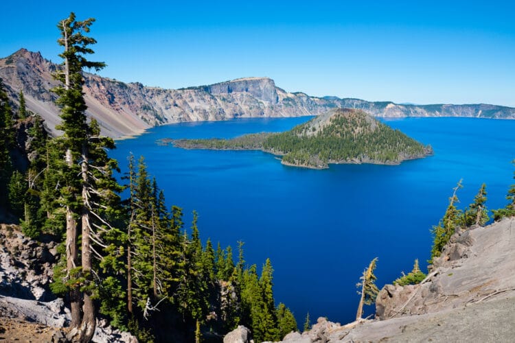 overview of crater lake np seen from above with blue water and island in lake