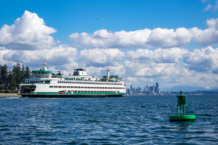 bainbridge seattle ferry on the water with seattle skyline in the background