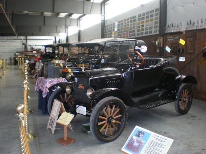 Old antique cars in black colors, convertible, in a showroom at a museum