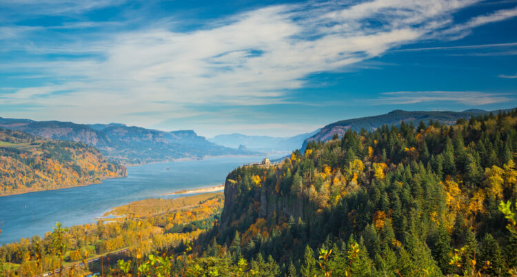 View of the Columbia River Gorge, with fall foliage, on a sunny day with some clouds.