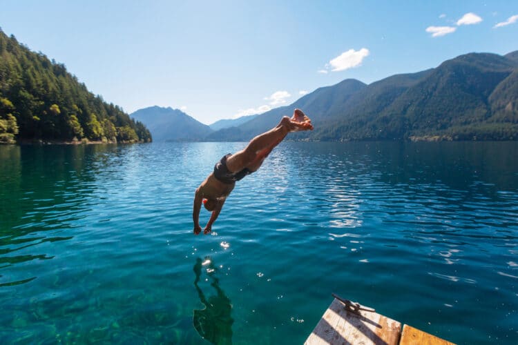 man diving into lake crescent