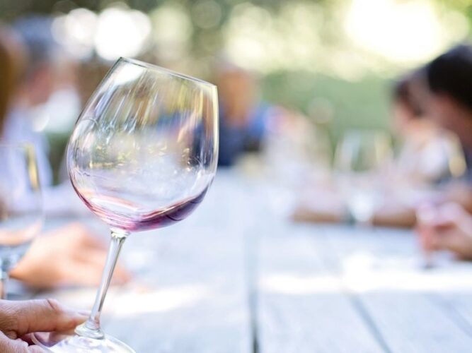 an empty glass in focus at a picnic table at an oregon coast winery