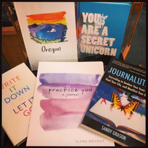 a selection of journals and personal development books at a hippie bookstore in portland