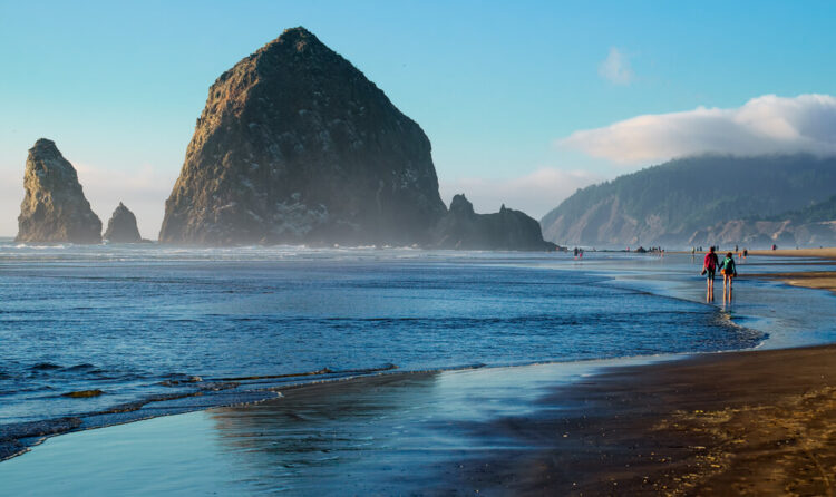 the giant looming haystack rock, walking here is one of the coolest things to do in cannon beach oregon