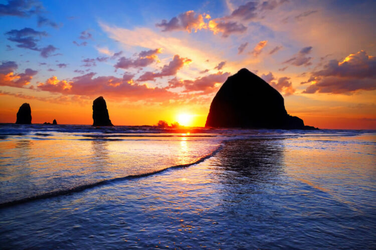 Sunset at Haystack Rock an enormous rock off the Oregon coast in Cannon beach