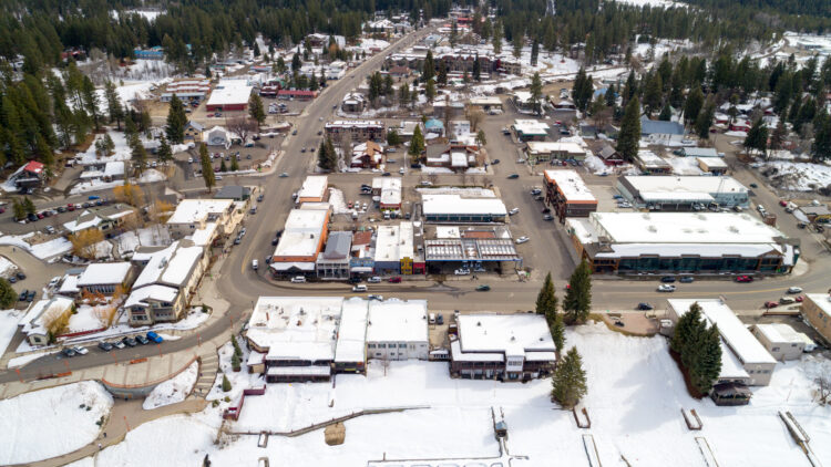 photo of the town of mccall idaho seen from above, an aerial photo in the winter with some light snow on the rooftops and ground